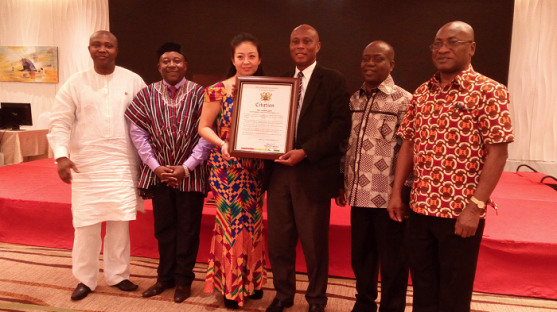 Mr and Mrs Ketu (middle with citation) with some officials of Ghana's Beijing Embassy
